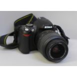 A Nikon D60 digital camera with a Nikon DX 18-55mm lens