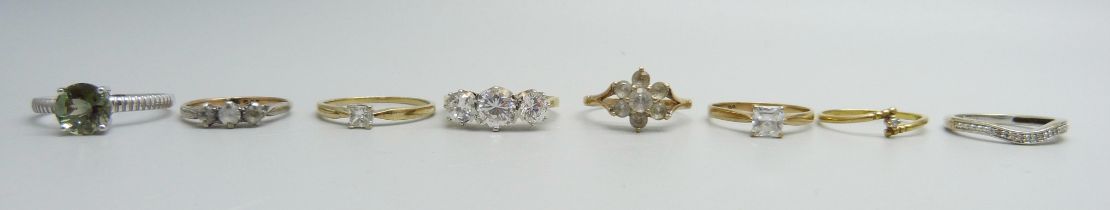 Eight 9ct gold rings, one set with 0.25 carat square diamond, 15g total weight
