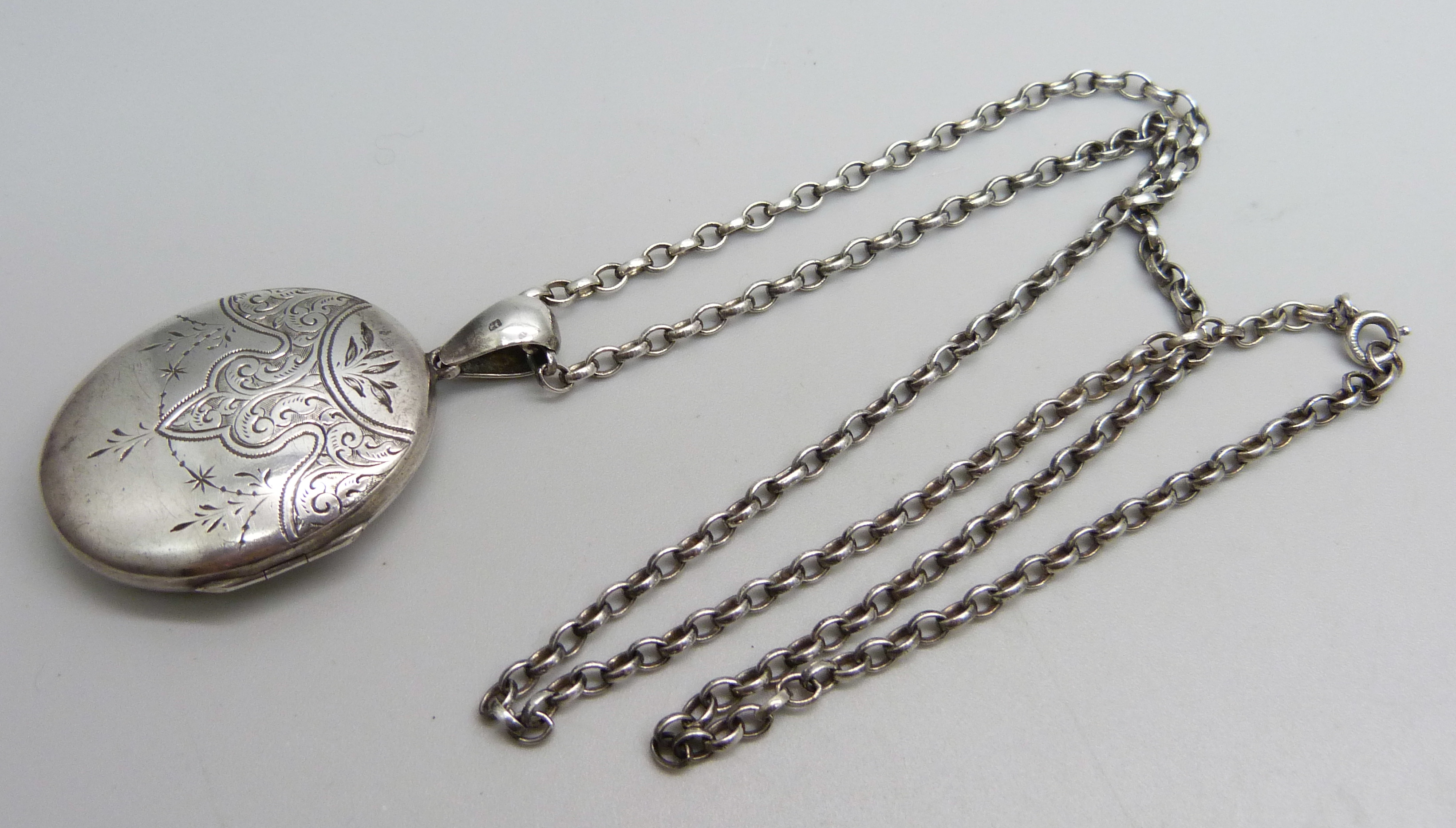 A Victorian silver locket, Birmingham 1881, on a modern silver belcher chain, 23g total, locket 5.