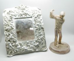A 925 silver covered model of a golfer, lacking club, and a mirror/frame with cherub detail,