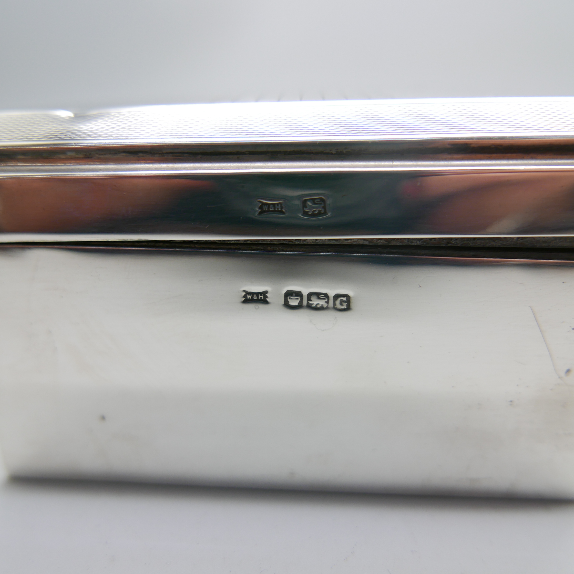 An Art Deco silver cigarette box, Walker & Hall, total weight with liner 654g, 17.5cm wide, dent - Image 3 of 7