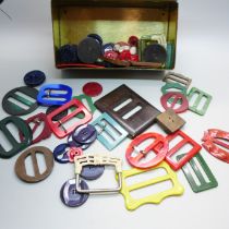 A tin of vintage Bakelite and early plastic buckles, buttons, early 20th Century onwards