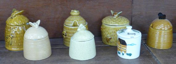 Seven pottery honey pots