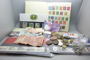 Twenty-one Royal Mail mint stamps and assorted coins, banknotes and album