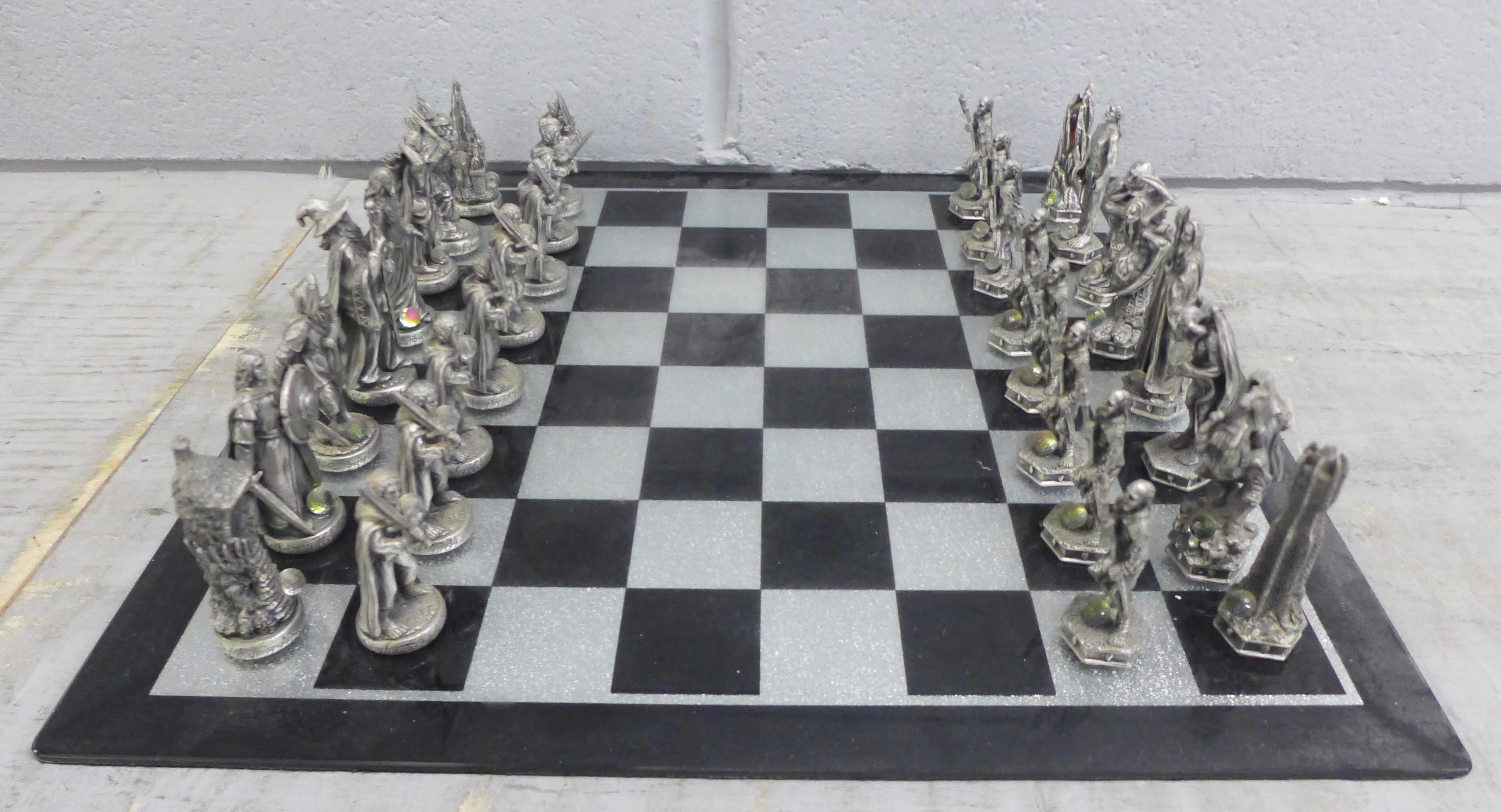 A Lord of The Rings pewter chess et by Tudor Mint, complete with glass board and pieces, in