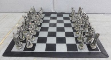 A Lord of The Rings pewter chess et by Tudor Mint, complete with glass board and pieces, in