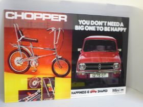 An acrylic shop window display panel advertising The Raleigh Chopper and the Mini (Austin Morris)
