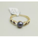 A silver gilt, pearl and garnet ring, U