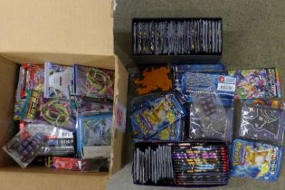 A box of English and Japanese Pokemon Evolutions packs, opened