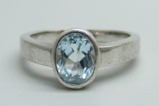 A 9ct white gold ring set with an oval topaz, 4.5g, N