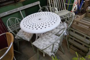 A white painted aluminium garden table and four teal coloured chairs