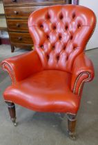 A Victorian style red leather lady's chair