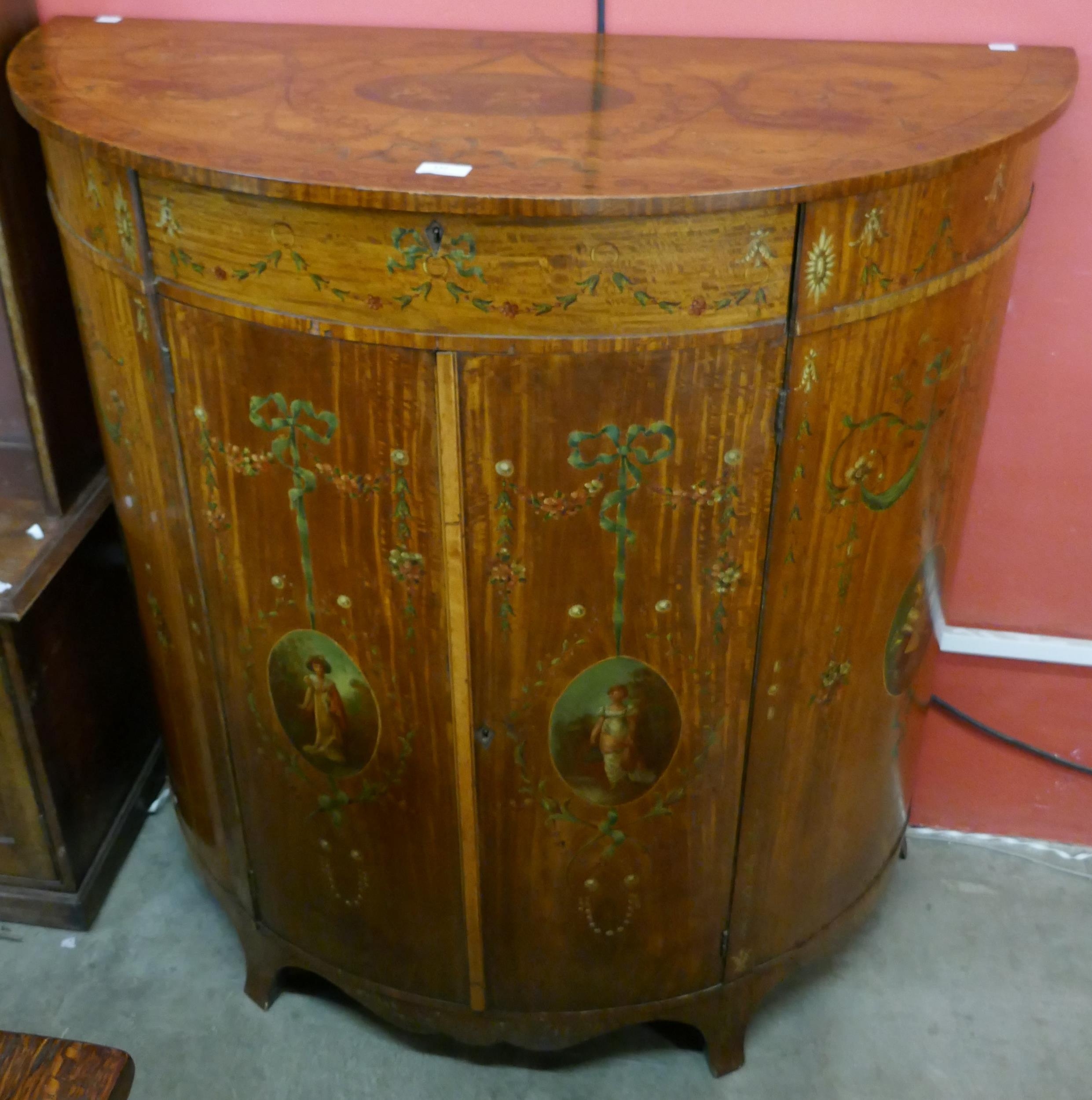 An Edward VII Sheraton Revival painted softwood demi lune side cabinet