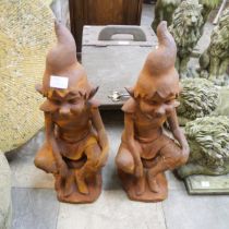 A pair of cast iron garden figure of a pixies