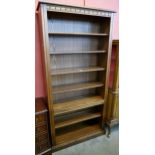 A tall Ercol Golden Dawn ash open bookcase