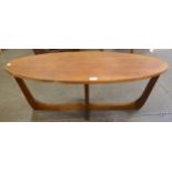 An oval teak coffee table