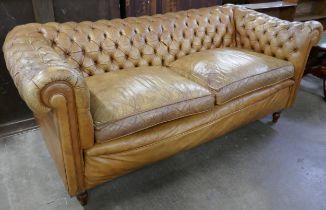 A tan leather Chesterfield settee