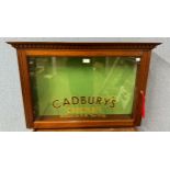 A mahogany shop display cabinet, bearing Cadbury's inscription