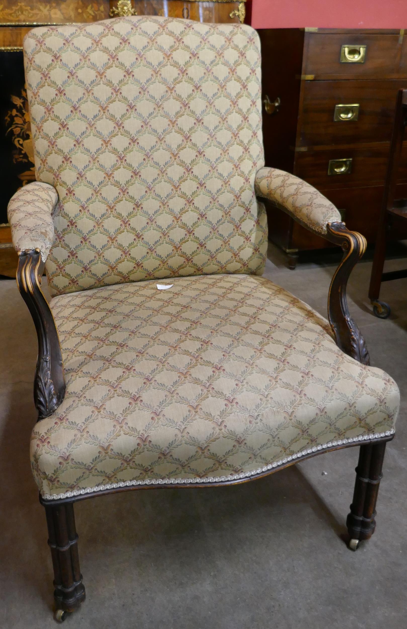 A George III Chippendale style carved mahogany and fabric upholstered Gainsborough chair
