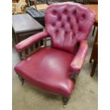 A Victorian oak and read leather upholstered armchair
