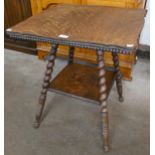 A Victorian oak barleytwist two tier occasional table