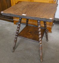 A Victorian oak barleytwist two tier occasional table