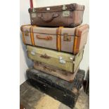 Four suitcases and a steamer trunk