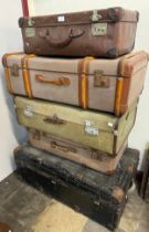 Four suitcases and a steamer trunk