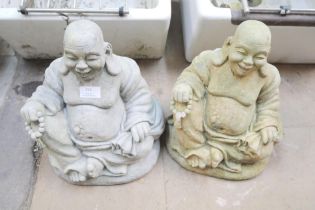A pair of concrete garden figures of seated Buddhas