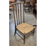 An Arts and Crafts Liberty & Co. style beech and rush seated fireside chair