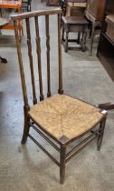 An Arts and Crafts Liberty & Co. style beech and rush seated fireside chair