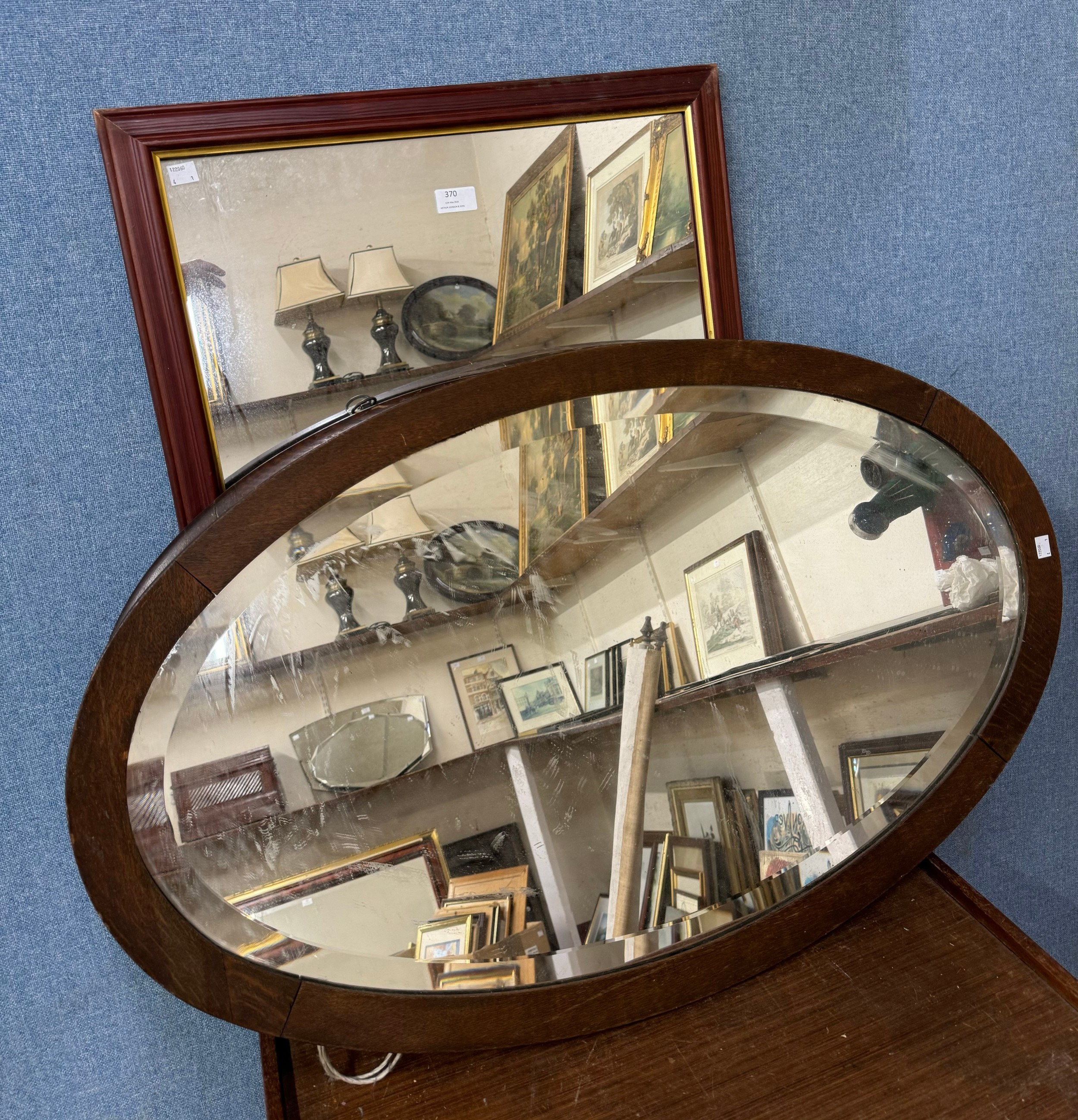 Two oak oval framed mirrors and one other