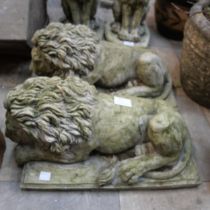 A pair of concrete garden figures of recumbent lions
