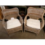 A pair of wicker garden chairs