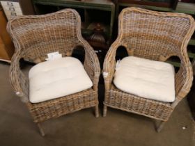 A pair of wicker garden chairs
