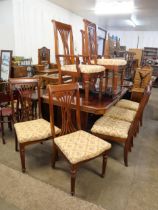 A mahogany extending dining table and eight chairs