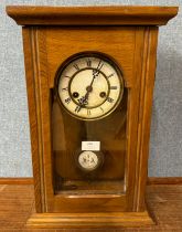 An early 20th Century oak wall clock