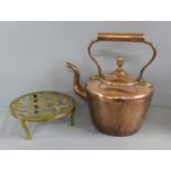 A Victorian copper kettle and a brass trivet