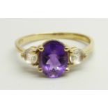 A 9ct gold ring set with a central amethyst and two white spinel, 2.8g, U