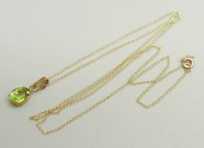 A 10k gold and peridot pendant on a fine 10k gold chain, 0.8g, chain approximately 46cm, pendant 1.