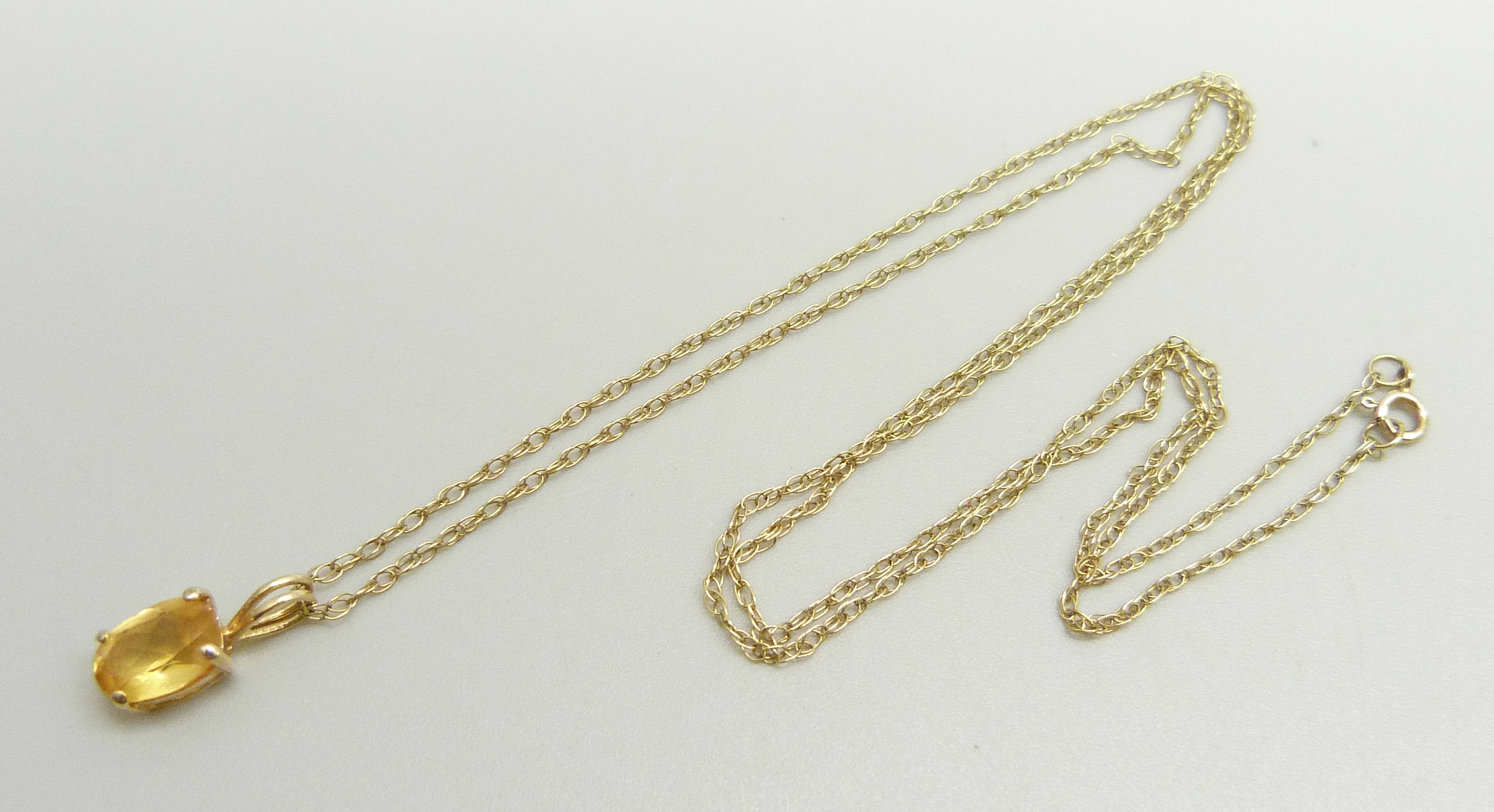 A 14ct gold pendant set with a citrine on a fine 9k gold chain, chain approximately 47cm, pendant