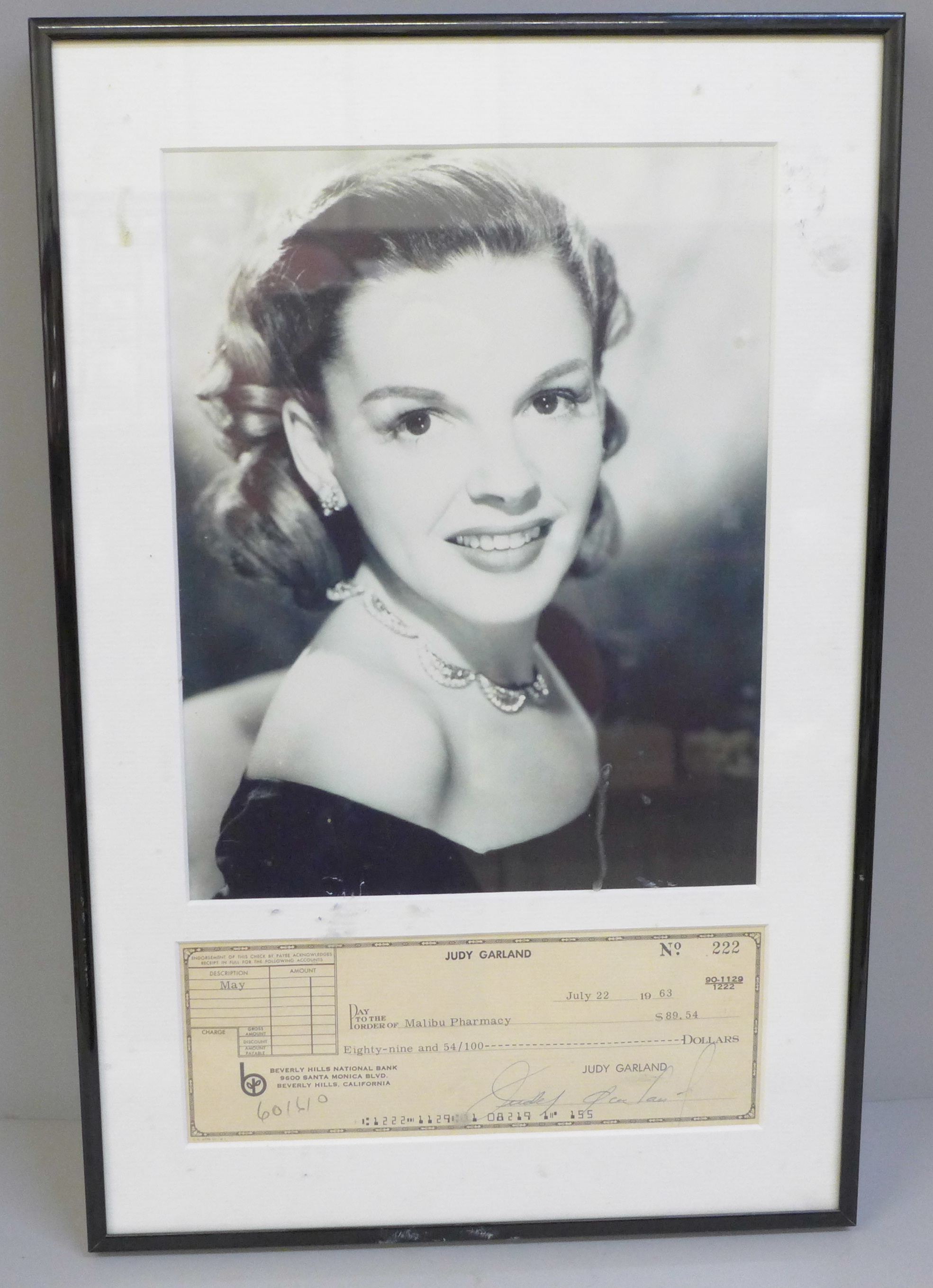 A Judy Garland signed cheque and photograph display with Rutland Autographs AFTAL registered C.O.A.