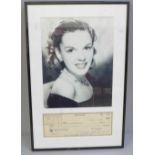 A Judy Garland signed cheque and photograph display with Rutland Autographs AFTAL registered C.O.A.