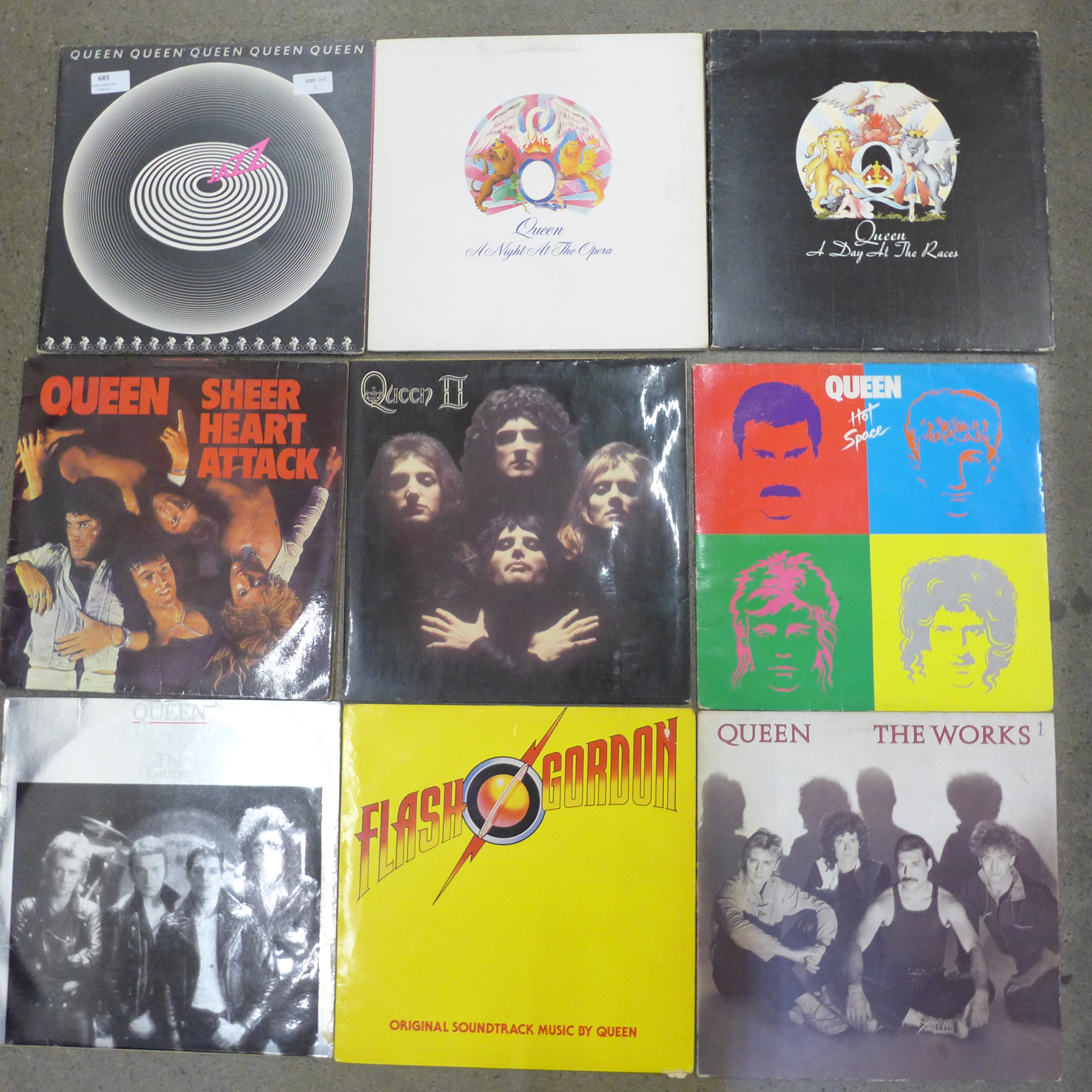 A collection of twelve Queen LP records and a 12" single