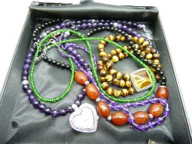 A silver and tiger's eye bracelet, a silver watch on a silver mounted amethyst chain, three other