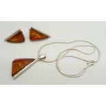 A silver and Baltic amber pendant on a silver chain and a pair of matching earrings, 4.5cm pendant