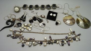 A collection of silver jewellery including a necklace with pearl drops, two shell pendants on