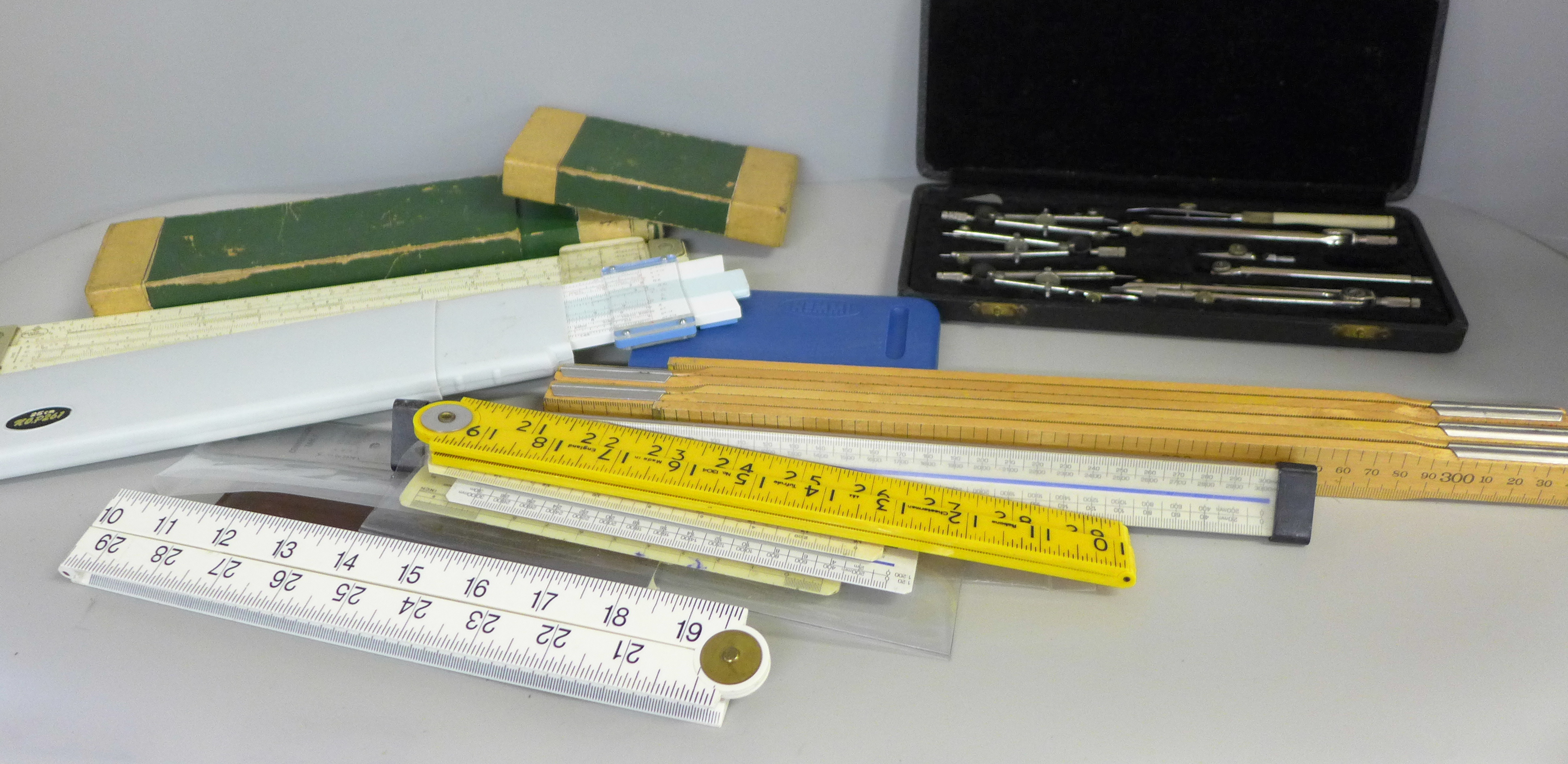 A Lee Guinness technical drawing set, slide rules and rulers, etc.