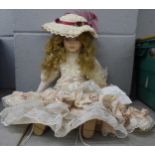 A bisque head doll with wind up musical mechanism