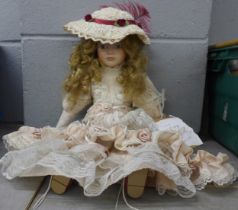 A bisque head doll with wind up musical mechanism